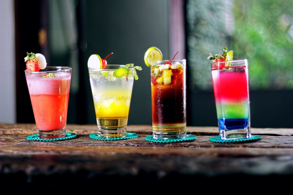 colorful cocktails lined up on the bar